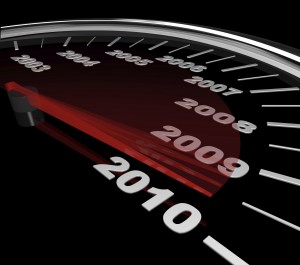 The red needle on a speedometer speeds toward the year 2010